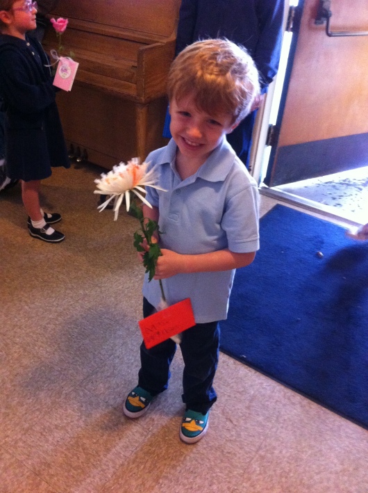 T is ready to greet his teacher Mrs. W on note-and-flower day of Teacher Appreciation Week.